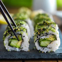 Fotobehang healthy kale and avocado sushi roll with chopsticks © Joshua Resnick