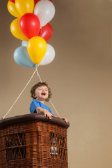 Little boy in a balloon - obrazy, fototapety, plakaty