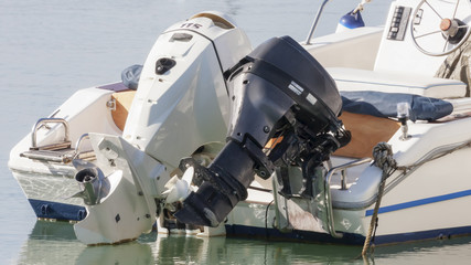 Pair of outboard engines mounted on a fiberglass motor boat