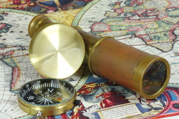 Old lunette and compass lie on the vintage map of the world.	