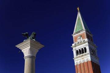 Fototapeta na wymiar Tower of St. Marks Campanile and the statue of Lion of Venice