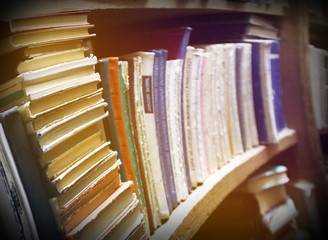 Obraz premium Many books on bookshelf in library, image with perspective distortion