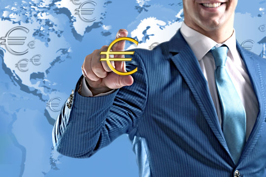 Business success strategy concept.Young man with currency sign in hands on world map background