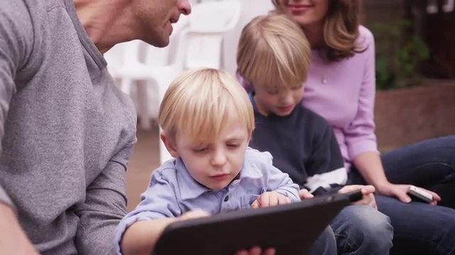 Close-up of cute young boy looking at tablet computer