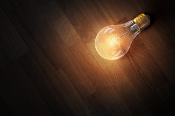 Light bulb on wooden surface