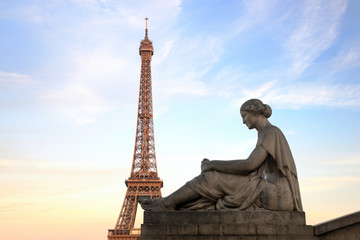 Fototapeta na wymiar Eiffel Tower from Trocadero with statue of woman, at sunset