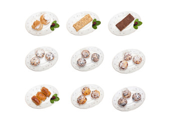 The collection of desserts on a white background. Cupcakes, cakes, puffs and eclairs on plates.