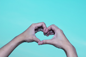 Female make hands heart on valentine day.
