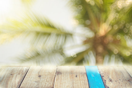 Nature Palm Leaf With Bokeh Sun Light On Old Empty Wood Table Background.