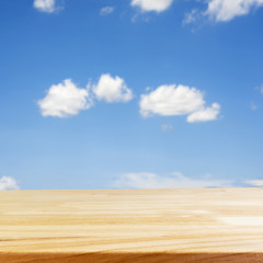 Fototapeta premium Wood table and blurry blue sky in background