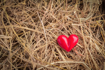 solid heart on a hay texture background.