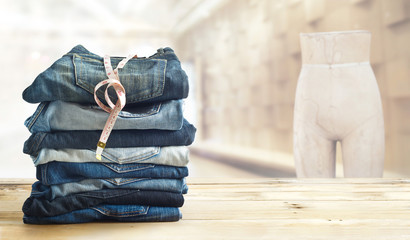 jeans with measure  in shop on wooden shelf and interior 