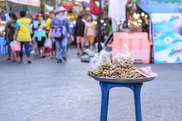 Boiled peanuts are selling at walking street market in Asian city.