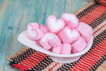 Colorful sweet marshmallow with sugar in a white-ware