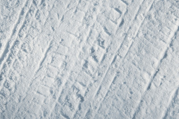 Car tire tracks in snow