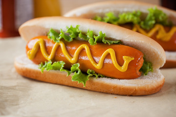 hot dogs with mustard on paper