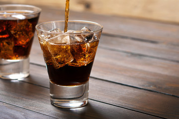 In a glass of whiskey and cola poured cola
