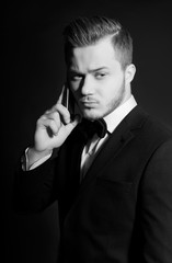 a young man in a suit talking on the phone, studio
