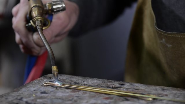 Craftsman jeweler creates a bracelet in his workshop