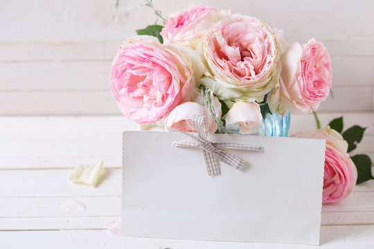 Background with sweet pink roses flowers  in blue vase and empty