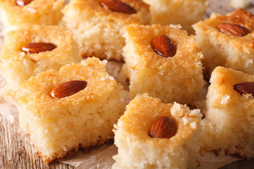Oriental sweets: basbousa with almonds close-up. horizontal
