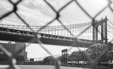 Manhattan Bridge seen through mesh fence, NYC, USA.