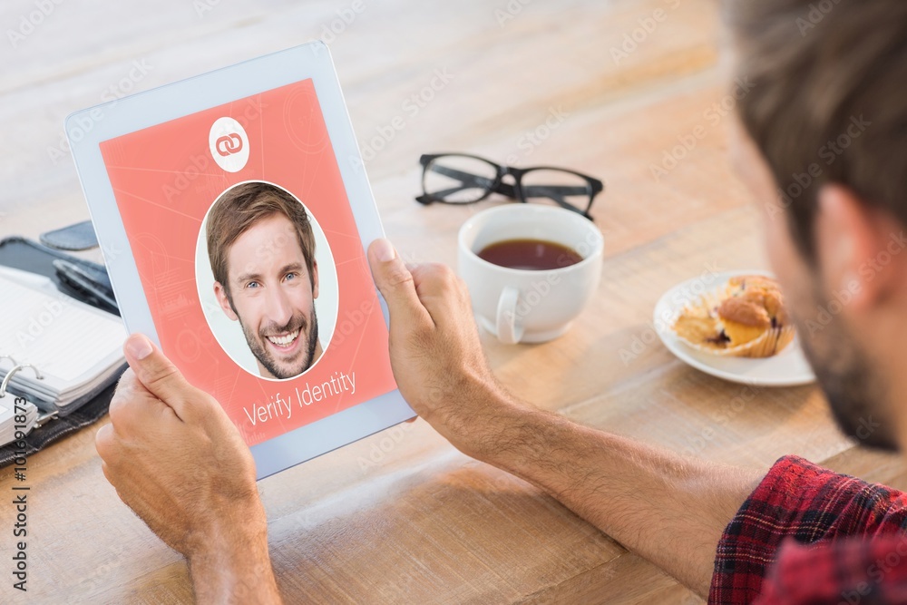 Poster composite image of rear view of man using tablet on wooden table