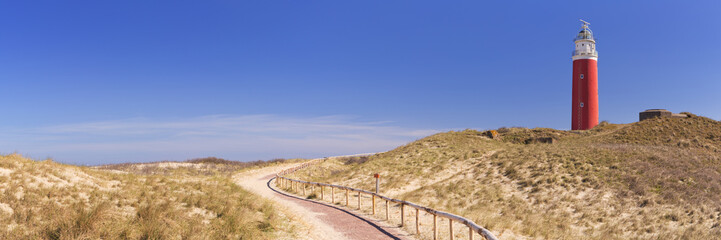 Lighthouse on the island of Texel in The Netherlands - obrazy, fototapety, plakaty