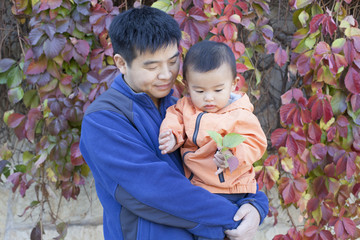 Happy Chinese father and son in front of Boston Ivy