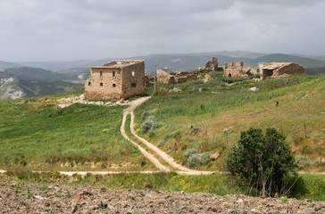 Hilly agricultural landscape with ruins of houses near town Ribera, Sicily, 