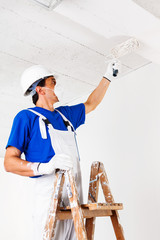 painter painting ceiling with paint roller - 101694264