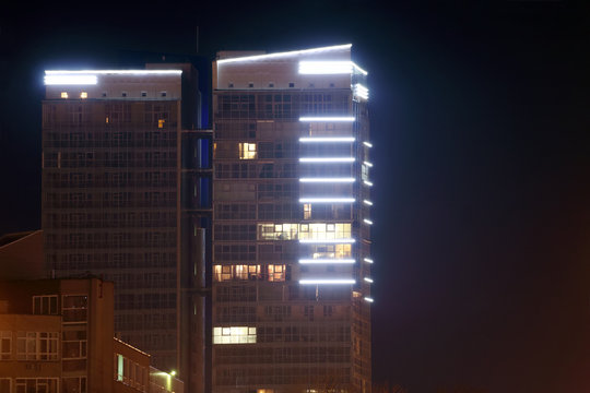 Part of residential building with illumination at dark night 