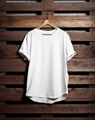 Blanc white tshirt hanging on wood background