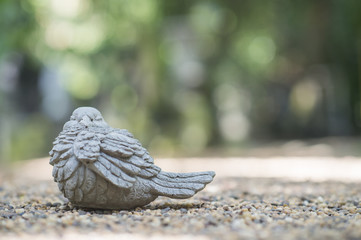 Bird statue background bokeh.