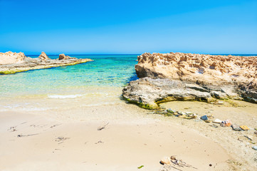 Fototapeta na wymiar Beautiful wild beach with clear turquoise water and white sand.