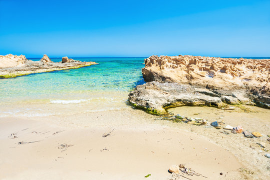 Beautiful wild beach with clear turquoise water and white sand.