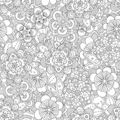 Doodle art flowers seamless pattern. Hand drawn black and white herbal background. Flowers and leaves