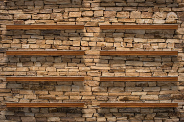 Empty top wooden shelves and stone wall background. For product