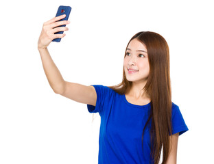 Beautiful woman taking a selfie with smartphone