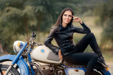 Naklejka na ściany i meble Biker Girl in Leather Jacket on Retro Motorcycle
