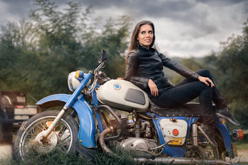 Fototapeta na wymiar Biker Girl in Leather Jacket on Retro Motorcycle