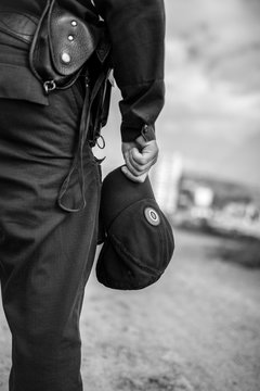 Detail of a police officer. Selective focus with shallow depth of field. Black and white toning.