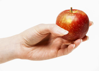 Woman holding red ripe apple in beautiful hand