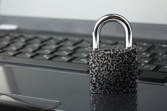 Computer security concept with a closed padlock on the keyboard