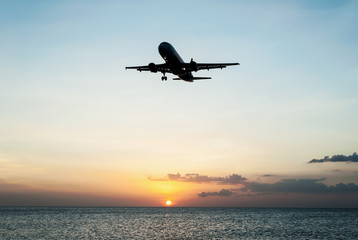 Fototapeta na wymiar Plane with sky sunset and sea