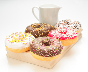 breakfast with donuts on kitchen table isolated on white