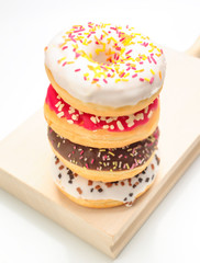 Colorful donuts on kitchen table isolated on white