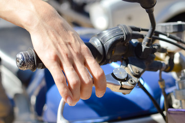 Closeup on rider's hand on the handlebar