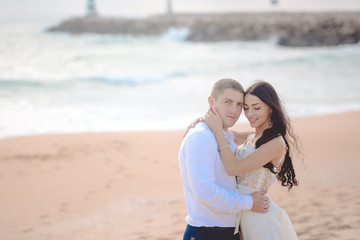 Romantic hugging loving couple on the beach