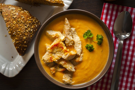 Carrot soup with chicken, top view and closeup